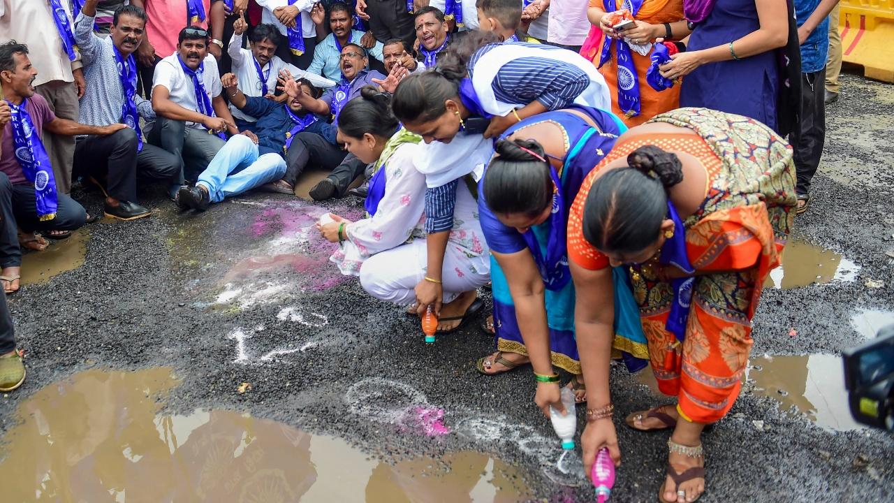 Protesters draw rangoli on the streets to express their disappointment about potholes in the city. Pic/PTI&nbsp;